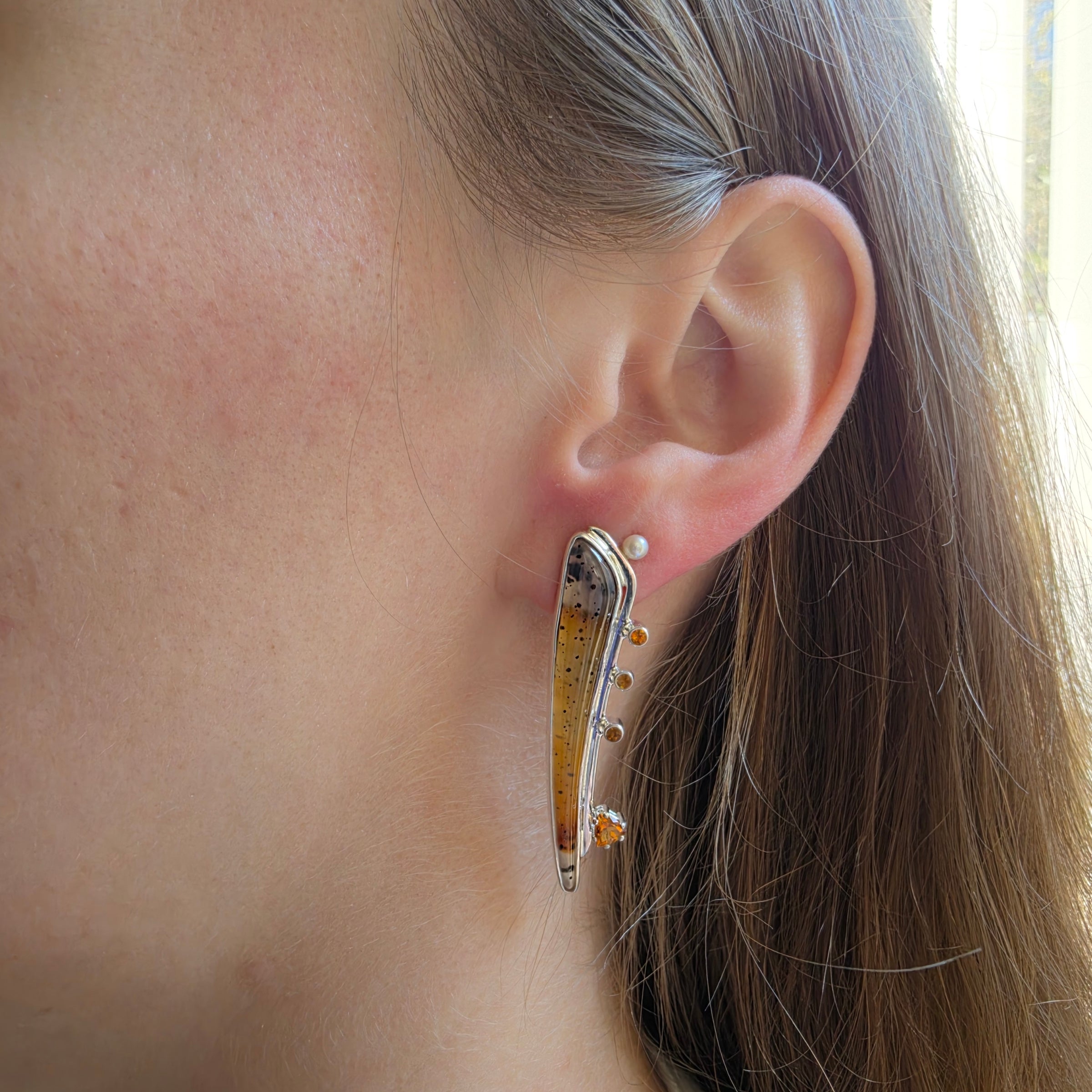 Modeling picture of Asymmetric Montana Agate earrings set in Sterling Silver with Citrine and Freshwater Pearls.