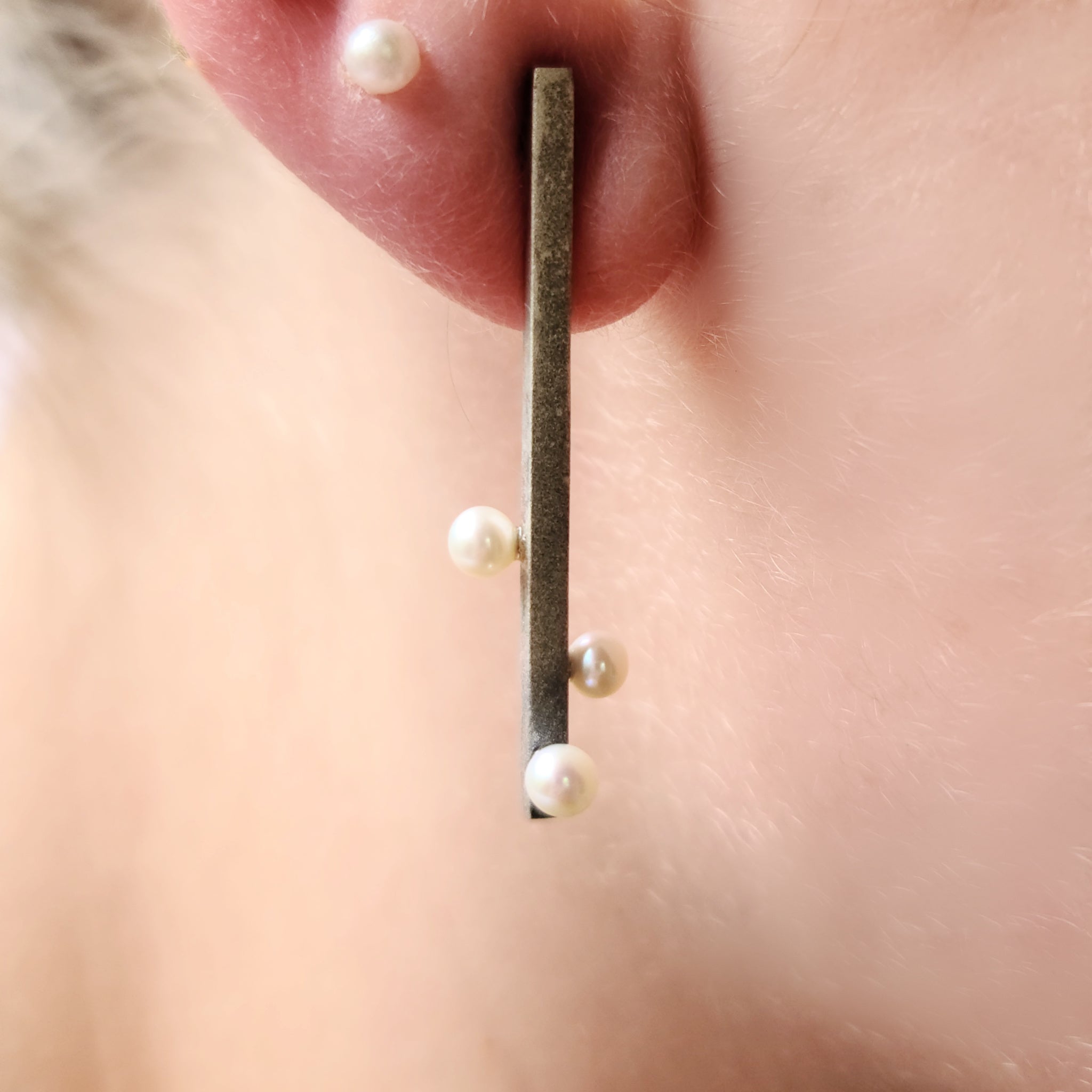 Model wearing oxidized and textured Sterling Silver earrings with Freshwater Pearls