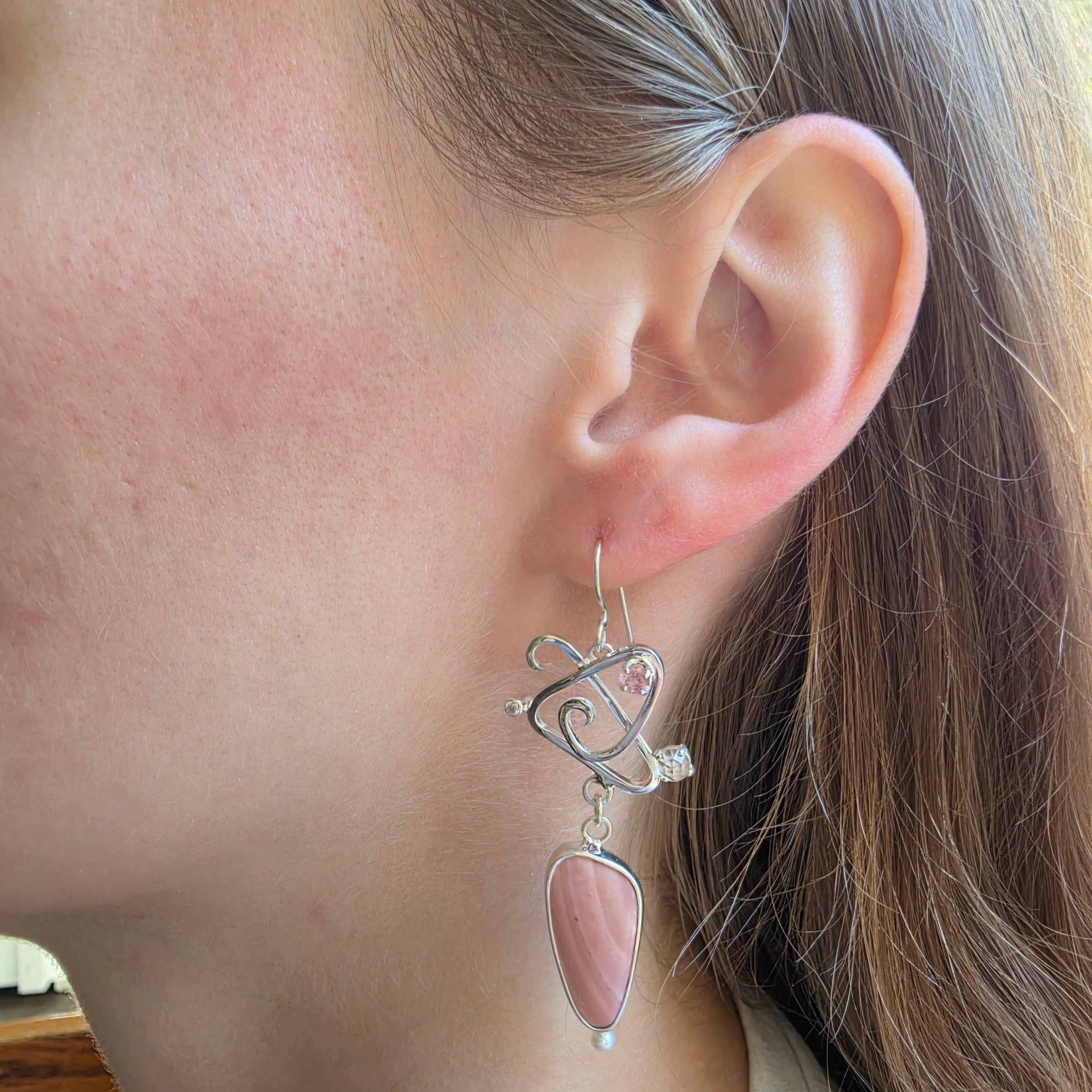 Modeling picture of Pink Opal asymmetric earrings with Pink tourmaline, Rose Quartz, Cubic Zirconia and Freshwater Pearls.