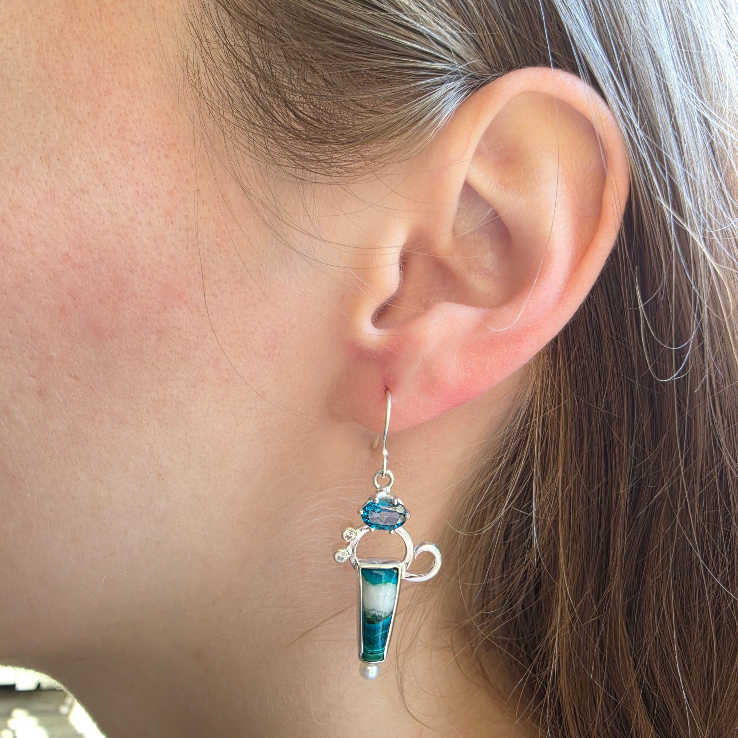 Model wearing Malachite/Azurite, Blue Topaz, Cubic Zirconia and Freshwater Pearl earrings set in Sterling Silver.