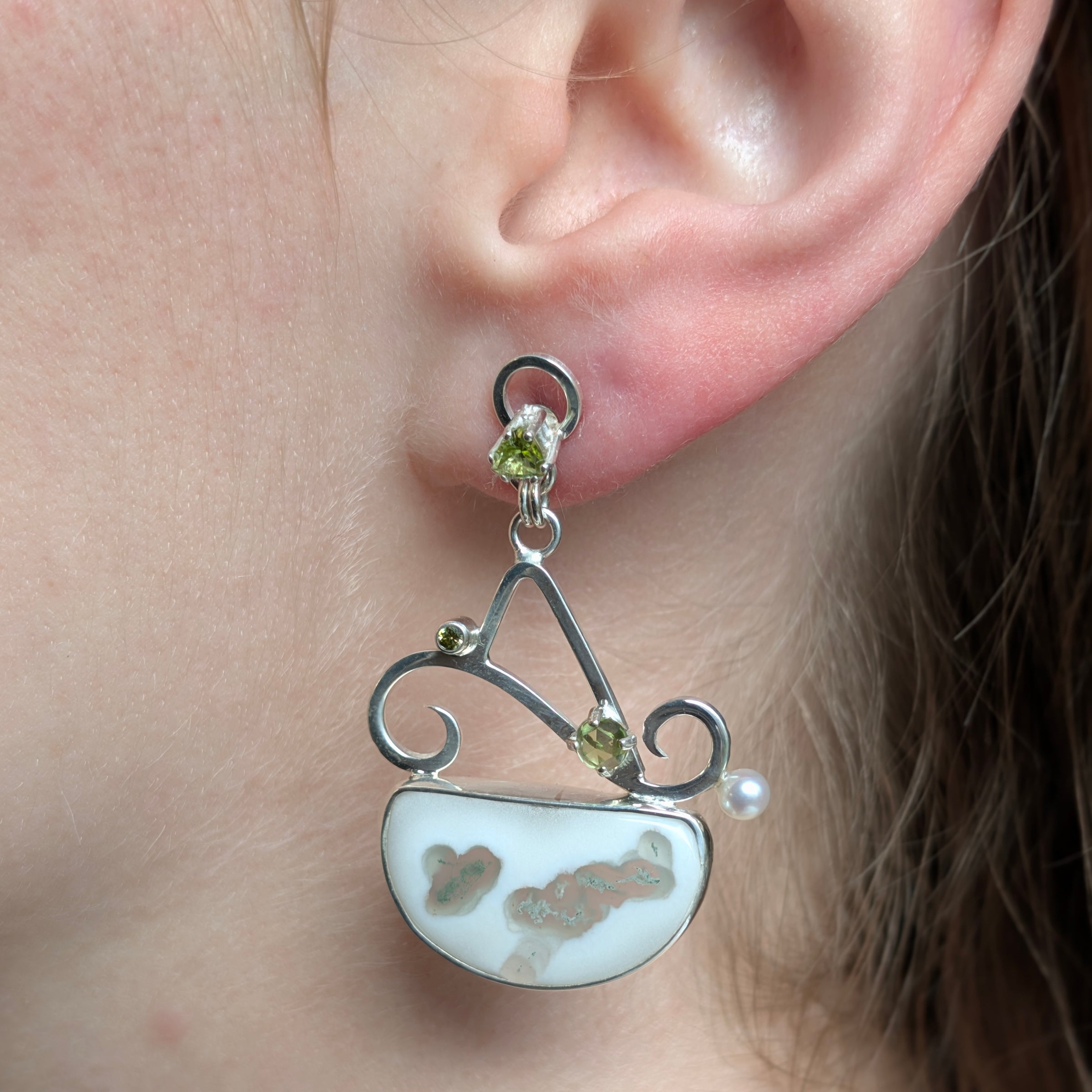 Model wearing Solar Quartz, Peridot, Cubic Zirconia and Freshwater Pearl earrings set in Sterling Silver.