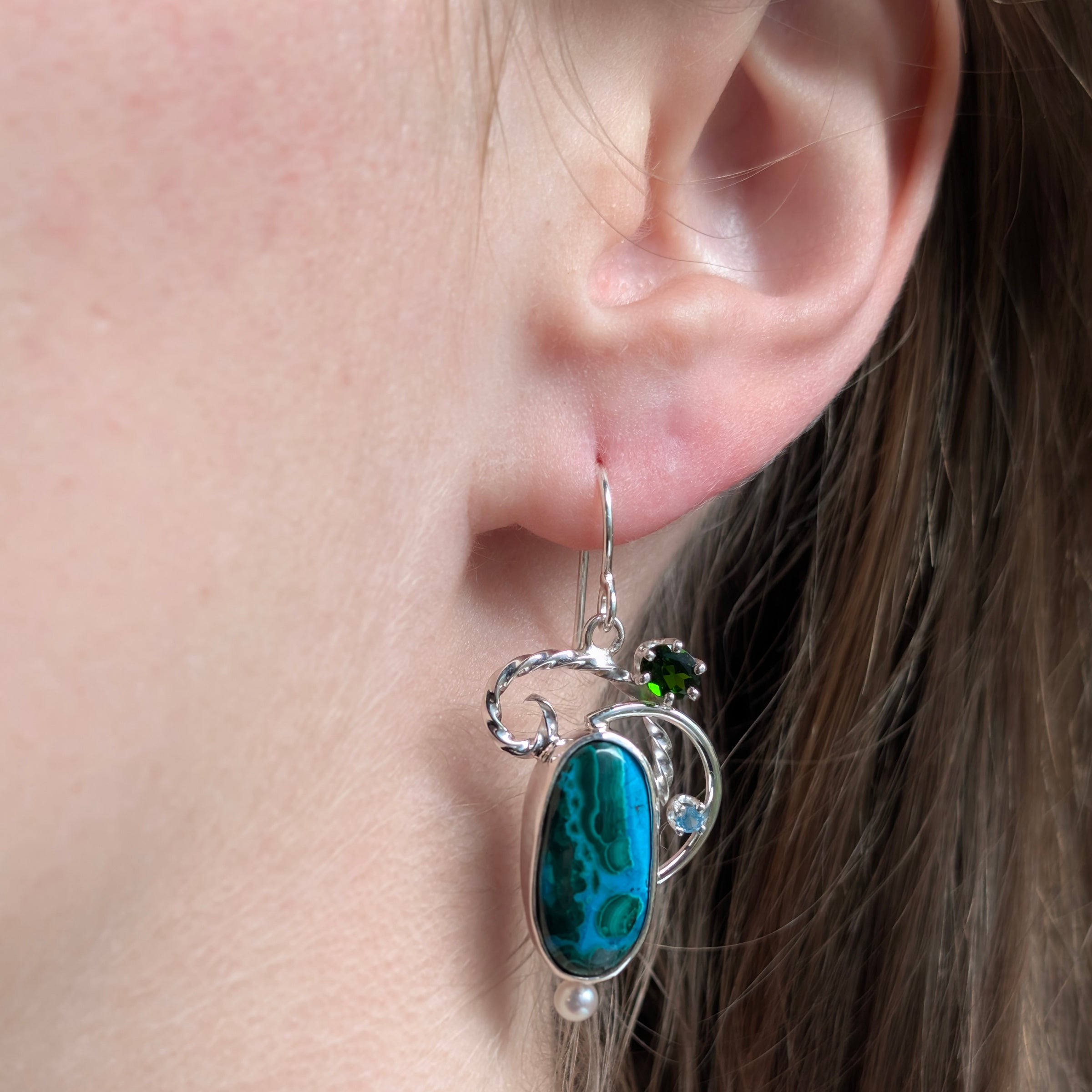 Model wearing Malachite/Chrysocolla, Chrome Diopside, Apatite and Freshwater Pearl earrings set in Sterling Silver.
