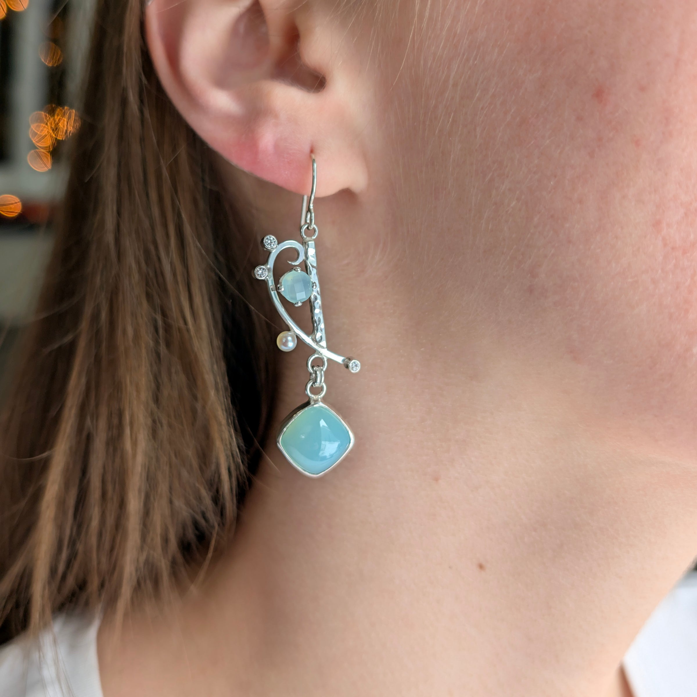 Chalcedony, Cubic Zirconia and Freshwater Pearl earrings set in Sterling Silver on a model.