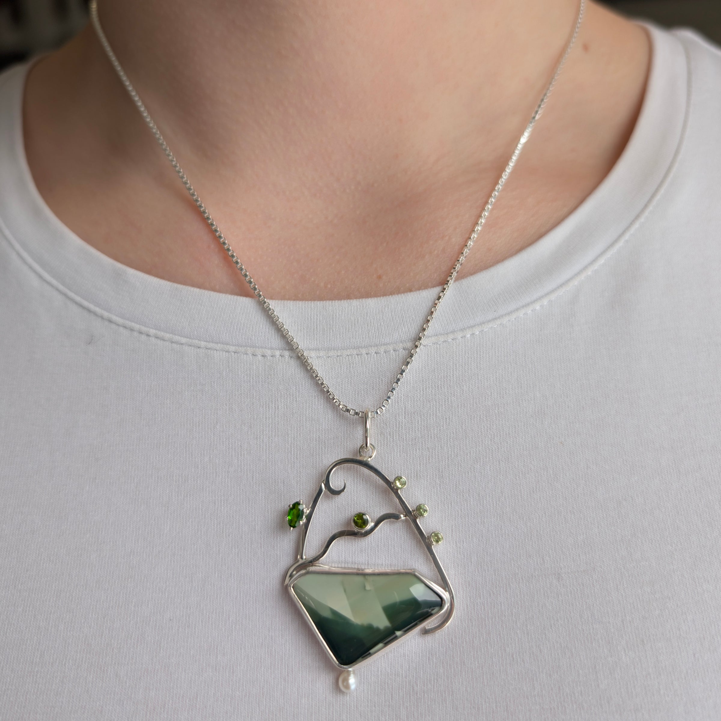 Sterling Silver Pendant with Green Imperial Jasper, Chrome Diopside, Green Cubic Zirconia, Peridot and Freshwater Pearl, includes 18 inch Sterling Silver box chain on a model.